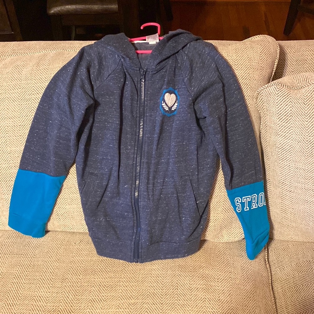 Athletic works gray sweater with blue sleeves. One sleeve says STRONG